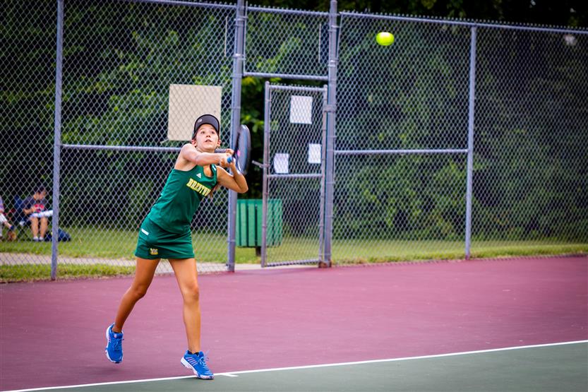 A tennis player hits the ball